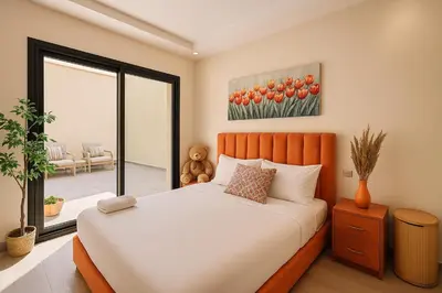 a bedroom with a bed and a large window at Cosy Patio sunny 2BR - new building - near oasis train station in Casablanca