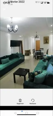 a living room with a green couch and a table at Ola Blanca 2 in Tamaris