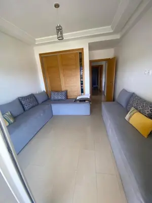 a living room with a blue couch in a room at Ola Blanca 2 in Tamaris