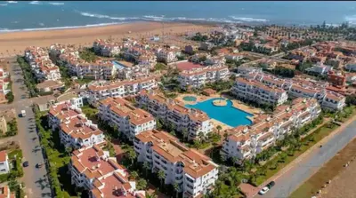 an aerial view of a resort near the beach at Appartement moderne bord de mer in Sidi Rahal