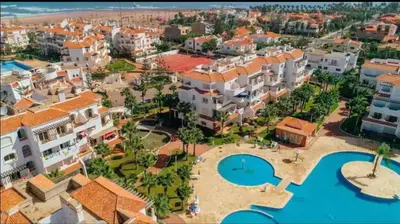 an aerial view of a resort with a swimming pool at Appartement moderne bord de mer in Sidi Rahal