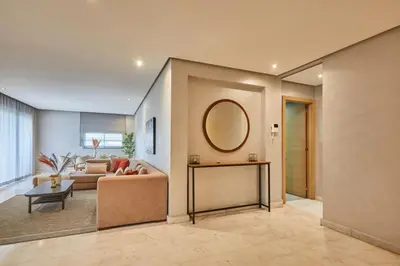 a living room with a couch and a mirror at Luxury 3 Bedroom Getaway in Bouskouras Finest in Bouskoura