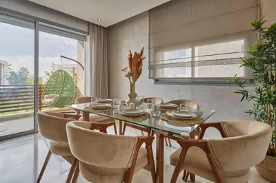 a dining room with a glass table and chairs at Luxury 3 Bedroom Getaway in Bouskouras Finest in Bouskoura