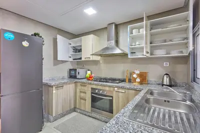 a kitchen with a stainless steel refrigerator and a sink at Luxury 3 Bedroom Getaway in Bouskouras Finest in Bouskoura