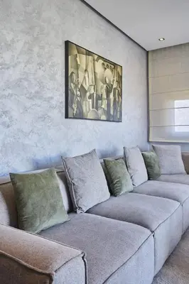a living room with two couches and a painting on the wall at Family-Friendly 3BR with Garden and Outdoor Space in Bouskoura
