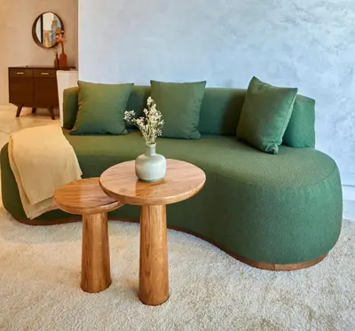 a living room with a green couch and a table at Family-Friendly 3BR with Garden and Outdoor Space in Bouskoura