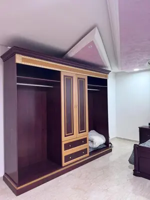 a room with a bed with a wooden closet at Appartement à Rabat in Rabat
