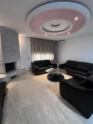 a living room with a couch and a fire place at Appartement à Rabat in Rabat