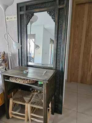 a wooden dressing table with a mirror in a room at vacance à Mansouria P Banus in Mansouria