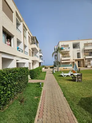 a brick walkway in front of a building at vacance à Mansouria P Banus in Mansouria