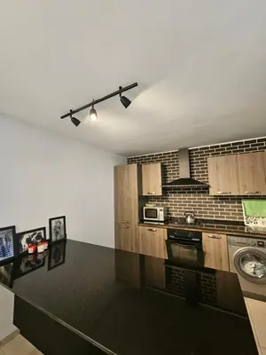 a kitchen with a black counter top in a room at vacance à Mansouria P Banus in Mansouria