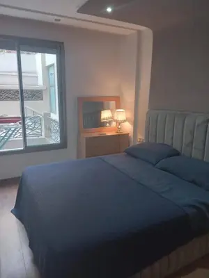a bedroom with a blue bed and a window at Bel Appartement Confort et Commodités au Cœur de Casablanca Belvédère in Casablanca