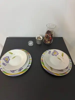 two plates with flowers on them sitting on a table at Sublime Cozy Chic Studio Condo in Downtown Casablanca in Casablanca