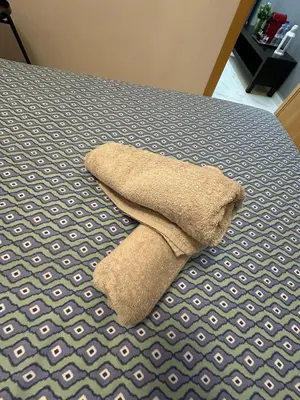 a pillow laying on top of a bed at Sublime Cozy Chic Studio Condo in Downtown Casablanca in Casablanca