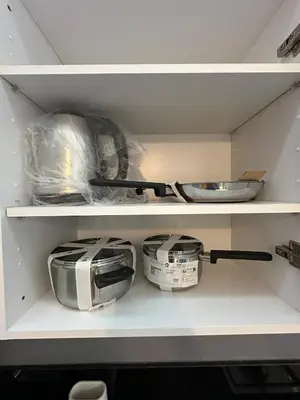 a kitchen shelf with bowls and pans on it at Sublime Cozy Chic Studio Condo in Downtown Casablanca in Casablanca