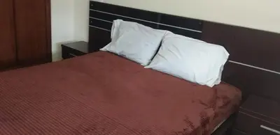 a bed with two pillows on top of it at Appartement Magnifique au coeur de la Corniche de Rabat in Rabat