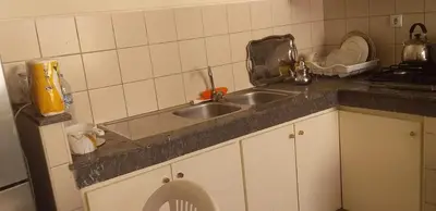 a kitchen with two sinks and a counter top at Appartement Magnifique au coeur de la Corniche de Rabat in Rabat