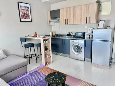 a small kitchen with a refrigerator and a sink at Nice Studio Casablanca Mohammed V Airport in Derroua