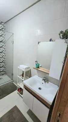 a bathroom with a white sink and a shower at Nice Studio Casablanca Mohammed V Airport in Derroua