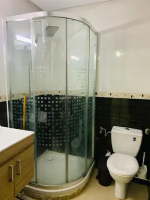 a bathroom with a toilet and a glass shower at Résidence journalière in Casablanca
