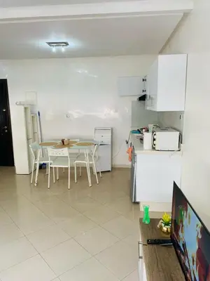 a kitchen with a table and a refrigerator at Résidence journalière in Casablanca