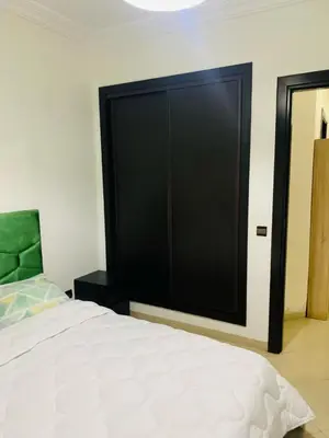 a bedroom with a large black closet and a bed at Résidence journalière in Casablanca