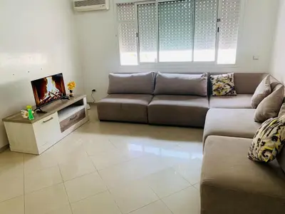 a living room with a couch and a tv at Résidence journalière in Casablanca