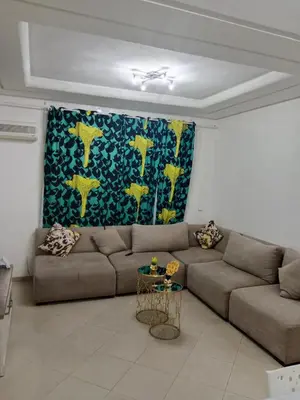 a living room with a couch and a painting at Résidence journalière in Casablanca