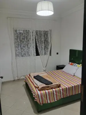 a bedroom with a bed and a window at Résidence journalière in Casablanca