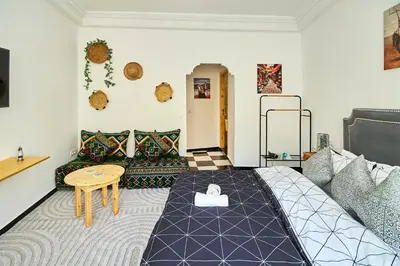 a room with a bed and a table in it at Luxury Moroccan Studio in Casablanca