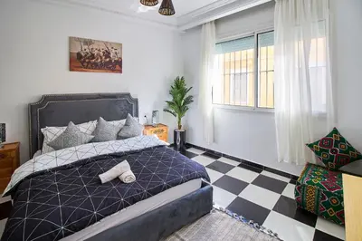 a bedroom with a bed and a checkered floor at Luxury Moroccan Studio in Casablanca