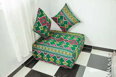 a chair with two pillows on a checkered floor at Luxury Moroccan Studio in Casablanca