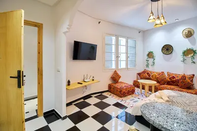 a living room with a couch and a table at Suite DeLuxe au coeur de la ville in Casablanca