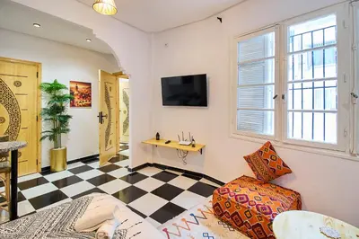 a living room with a checkered floor at Suite DeLuxe au coeur de la ville in Casablanca