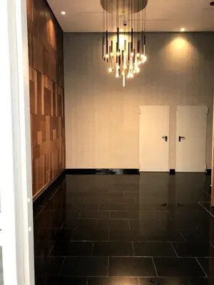 a hallway with four doors and a chandelier at Beautiful Apartment Best View in Casablanca