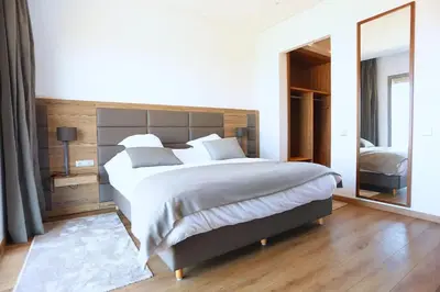 a bedroom with a large bed and a mirror at Luxury Apartment, Seaview Close Beach in Casablanca