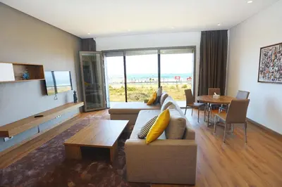 a living room with a couch and a table at Luxury Apartment, Seaview Close Beach in Casablanca