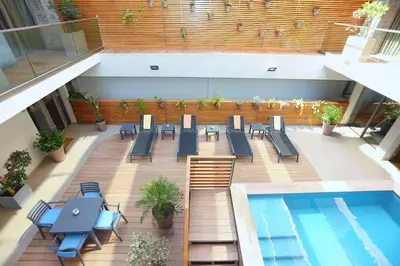 an overhead view of a patio with a pool and tables and chairs at Luxury Apartment, Seaview Close Beach in Casablanca