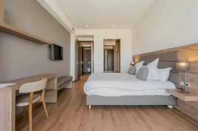 a bedroom with a large white bed and a desk and a desk at Luxury Apartment, Seaview Close Beach in Casablanca