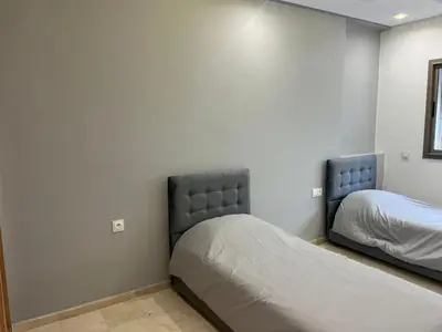 a bedroom with two beds in a room at downtown luxurious flat quartier Gauthier in Casablanca