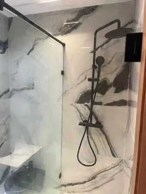 a shower with a glass door in a bathroom at downtown luxurious flat quartier Gauthier in Casablanca