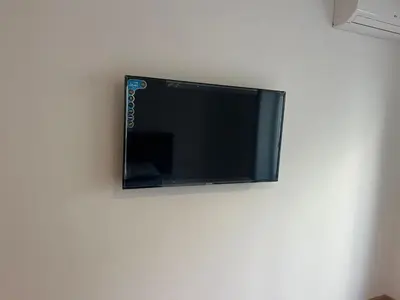 a flat screen tv hanging on a wall at downtown luxurious flat quartier Gauthier in Casablanca