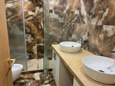 a bathroom with two sinks and a shower at downtown luxurious flat quartier Gauthier in Casablanca