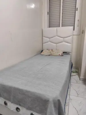 a bed in a white room with a mattress at Alia Apartment 25 in Casablanca