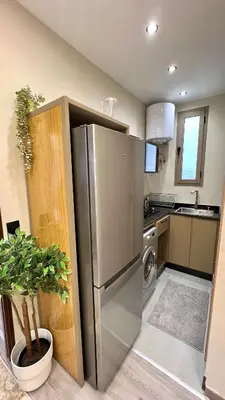 a kitchen with a stainless steel refrigerator and a dishwasher at Studio chic et confortable au coeur de rabat agdal in Rabat