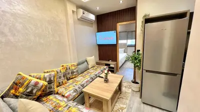 a living room with a couch and a table at Studio chic et confortable au coeur de rabat agdal in Rabat