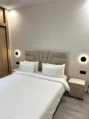 a bedroom with a large bed with white sheets at Studio chic et confortable au coeur de rabat agdal in Rabat