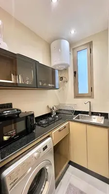 a kitchen with a washing machine and a sink at Studio chic et confortable au coeur de rabat agdal in Rabat