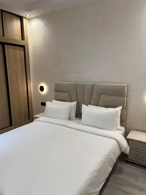 a bedroom with a large bed with white sheets at Studio chic et confortable au coeur de rabat agdal in Rabat