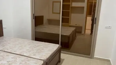 a room with two beds and a mirror at Ferme a Ain Tizgha Benslimane in O Ben Slimane